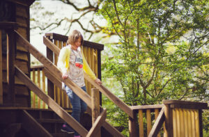 Young lady enjoying the tree house at Hatchlands
