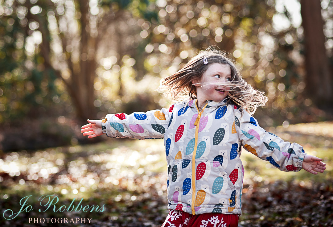 Child having fun on a family photoshoot in Surrey - Hampton Court Family Photographer