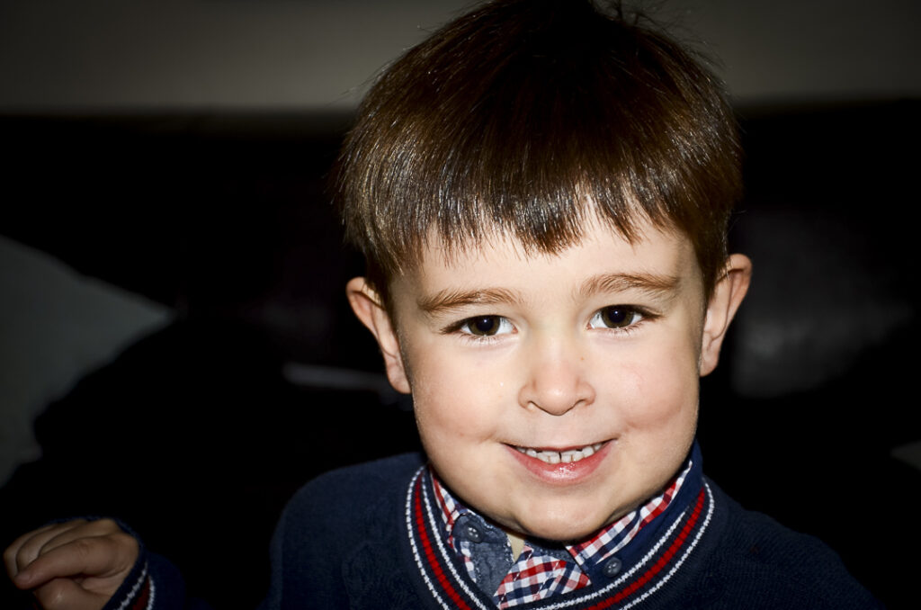 Little boy with a cheesy grin