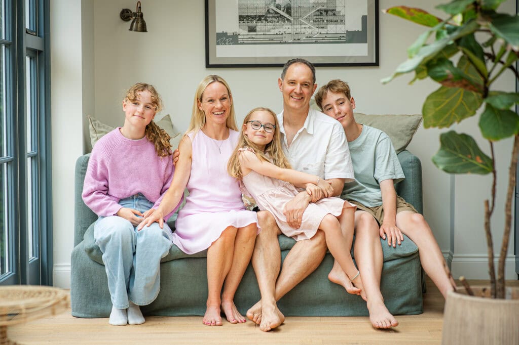 Family smiling being photographed at home in natural light