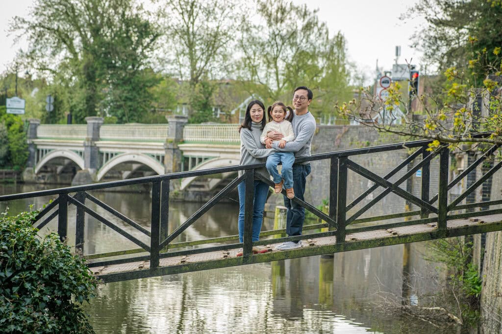Parents lifting their toddler during a outdoor photoshoot
